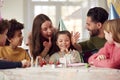 Girl With Candles On Birthday Cake At Surprise Party With Parents And Friends At Home Royalty Free Stock Photo
