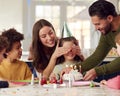 Girl With Candles On Birthday Cake At Surprise Party With Parents And Friends At Home Royalty Free Stock Photo