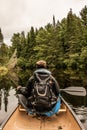 Girl canoeing with Canoe on the lake of two rivers in the algonquin national park in Ontario Canada on cloudy day Royalty Free Stock Photo