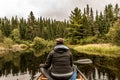 Girl canoeing with Canoe on the lake of two rivers in the algonquin national park in Ontario Canada on cloudy day Royalty Free Stock Photo