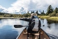 Girl canoeing with Canoe on the lake of two rivers in the algonquin national park in Ontario Canada on sunny cloudy day Royalty Free Stock Photo