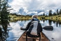 Girl canoeing with Canoe on the lake of two rivers in the algonquin national park in Ontario Canada on sunny cloudy day Royalty Free Stock Photo