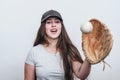 Girl in cap with baseball glove catches the ball, serving in game Royalty Free Stock Photo