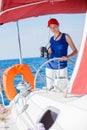 Girl captain on board of sailing yacht on summer cruise. Travel adventure, yachting with child on family vacation. Royalty Free Stock Photo