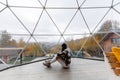 Girl Captured in a Glass Dome Amidst Autumn Mountains