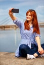 Girl capturing beautiful moments in nature by the river