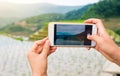 Girl capturing rice terrace scenery with a phone