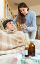 Girl caring for sick husband in living room