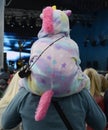 A girl in a carnival costume on her fatherÃ¢â¬â¢s shoulders is watching a concert.