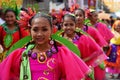 Girl carnival dancers in various costumes dance along the road