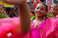 Girl carnival dancers in various costumes dance along the road