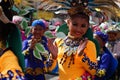 Girl carnival dancers in various costumes dance along the road