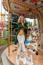 Girl on a carousel in an amusement park Royalty Free Stock Photo