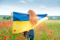 Girl carries fluttering blue and yellow flag of Ukraine in field Royalty Free Stock Photo