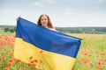 Girl carries fluttering blue and yellow flag of Ukraine in field Royalty Free Stock Photo