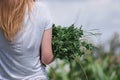 girl carries a handful of grass. concept of harmony with nature