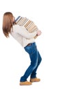 A girl carries a heavy pile of books. back view. Rear view people collection.