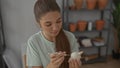 Girl carves white clay figurine with carving tool using bare hands in pottery studio; creative passion concentration Royalty Free Stock Photo