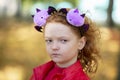 A girl in casual clothes and with a headband with Halloween horns Royalty Free Stock Photo