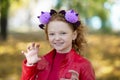 A girl in casual clothes and with a headband with halloween horns scares you Royalty Free Stock Photo