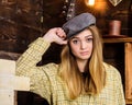 Girl in casual outfit with kepi in wooden vintage interior. Girl tomboy spend time in house of gamekeeper. Tomboy