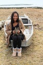 Girl with cat on punt by frozen lake