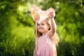 A girl catches butterflies with a pink juice on a summer day Royalty Free Stock Photo