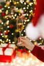 The girl catches a glass of champagne and celebrates Christmas and New Year. Royalty Free Stock Photo