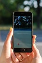 The girl catches a Pokemon on the road, close-up