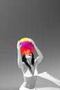 Girl catching beach ball on sunny beach in Spain. Black and white with ball in color. Royalty Free Stock Photo