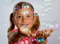 Girl catching bubbles