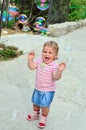 Girl catching soap bubbles