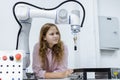 Girl caucasoid education electronic robotic arm on table at class room. learning innovation robot electronic for future AI. System