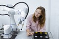 Girl Caucasoid education electronic robotic arm on table at class room. Learning innovation robot electronic for future. Royalty Free Stock Photo