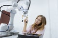 Girl caucasoid education electronic robotic arm on table at class room. learning innovation robot electronic for future AI. System