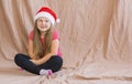 Girl celebrates new year and christmas wearing a santa claus siit hat and dreams of gifts copy space Royalty Free Stock Photo