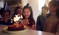 Girl Celebrating Birthday With Group Of Friends At Home Being Given Cake Decorated With Sparkler Royalty Free Stock Photo