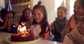 Girl Celebrating Birthday With Group Of Friends At Home Being Given Cake Decorated With Sparkler Royalty Free Stock Photo