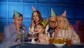 Girl celebrating birthday party with parents, senior grandparents family blowing out candles on cake Royalty Free Stock Photo