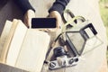 Girl with cell phone, books and old camera Royalty Free Stock Photo