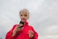 Girl with cell phone and cloudy sky Royalty Free Stock Photo