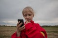 Girl with cell phone and cloudy sky Royalty Free Stock Photo