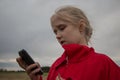 Girl with cell phone and cloudy sky Royalty Free Stock Photo