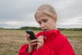 Girl with cell phone and cloudy sky Royalty Free Stock Photo