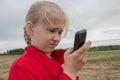 Girl with cell phone and cloudy sky Royalty Free Stock Photo