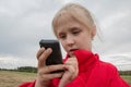 Girl with cell phone and cloudy sky Royalty Free Stock Photo