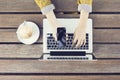 Girl with cell phone, cup of cappuccino and laptop on wooden tab Royalty Free Stock Photo