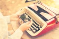 Girl with cell phone and typewriter Royalty Free Stock Photo