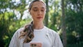 Girl cellphone walking forest listening music in modern wireless earbuds closeup Royalty Free Stock Photo