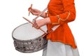 A girl in ceremonial red clothes plays with drumsticks on a drum on a white isolated background Royalty Free Stock Photo
